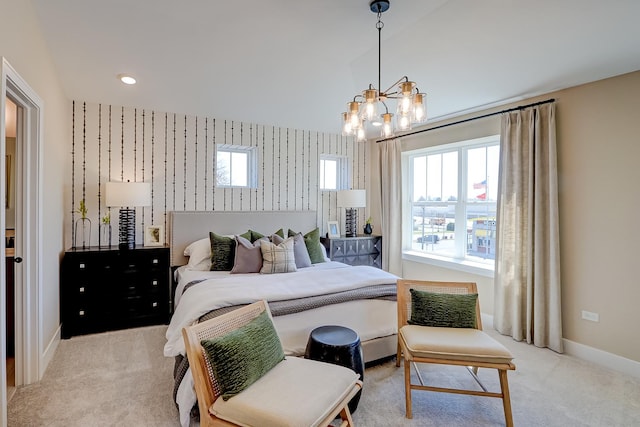 carpeted bedroom with an inviting chandelier