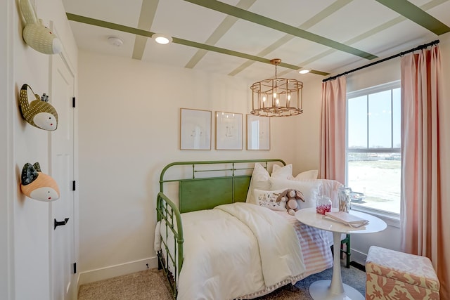 carpeted bedroom featuring multiple windows and a chandelier