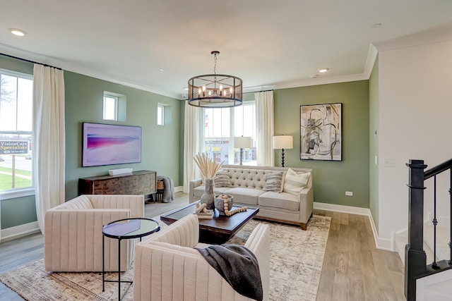 living room featuring crown molding, a wealth of natural light, and light hardwood / wood-style floors