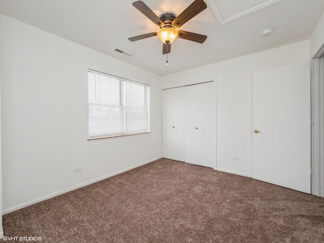 unfurnished bedroom with ceiling fan, a closet, and carpet