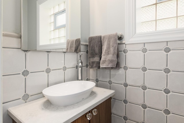 bathroom featuring vanity and tile walls