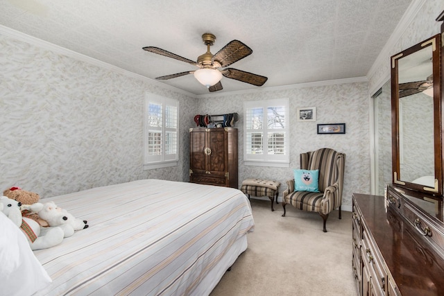 bedroom featuring light carpet, ceiling fan, crown molding, and a textured ceiling