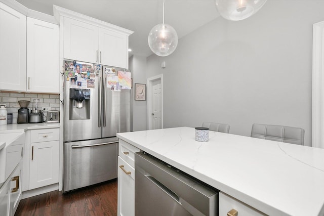 kitchen with white cabinetry, stainless steel appliances, tasteful backsplash, dark hardwood / wood-style flooring, and decorative light fixtures