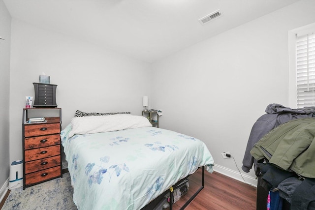 bedroom with hardwood / wood-style flooring