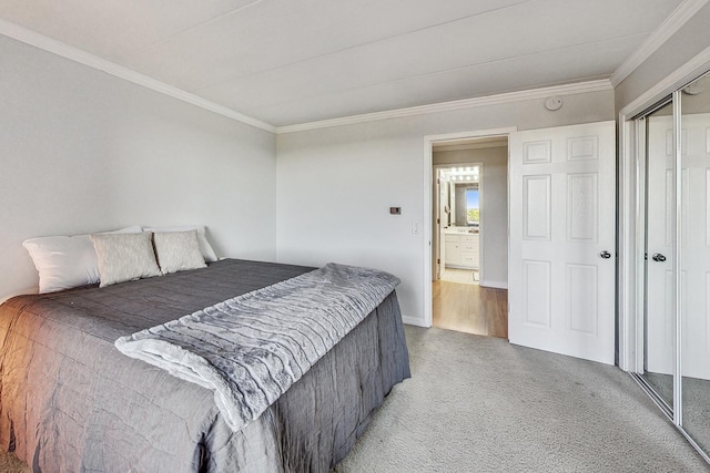 carpeted bedroom with ornamental molding and a closet