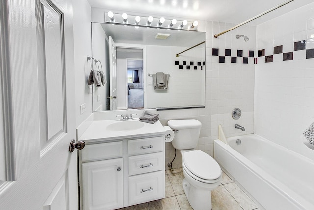 full bathroom featuring tiled shower / bath combo, tile patterned floors, vanity, and toilet