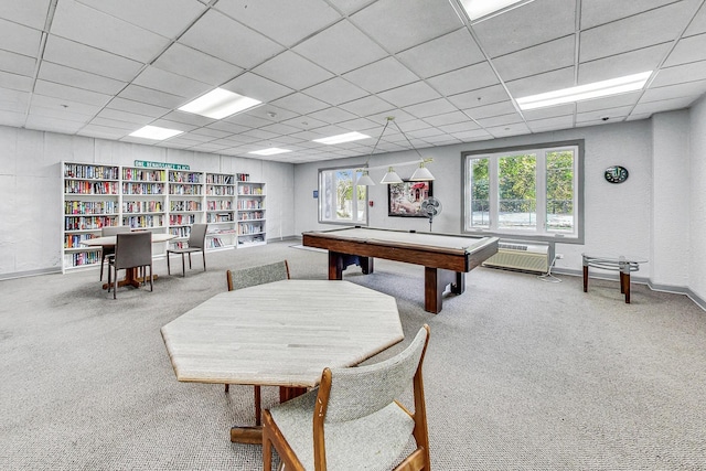 recreation room featuring carpet flooring and a drop ceiling