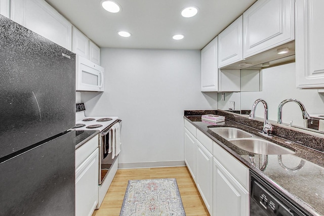 kitchen with white cabinetry, sink, black appliances, and dark stone counters