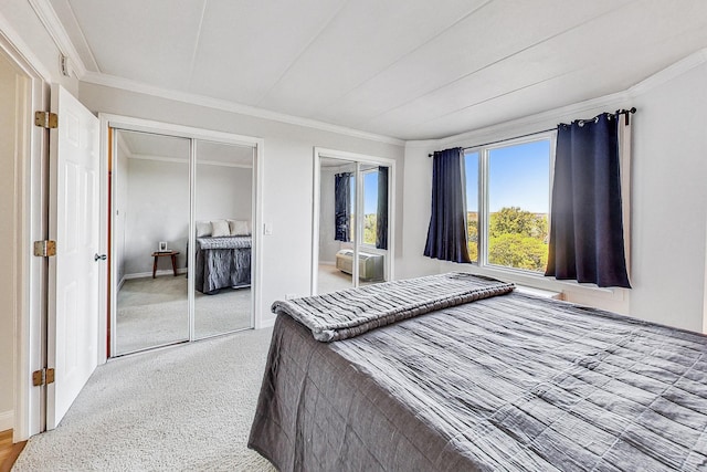 bedroom with light carpet, crown molding, and multiple closets