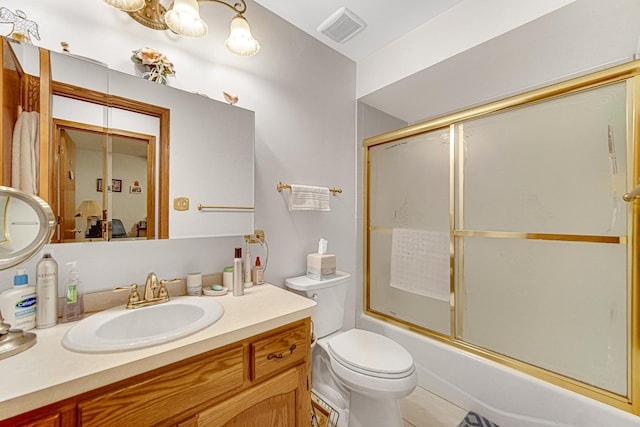 full bathroom featuring enclosed tub / shower combo, vanity, and toilet