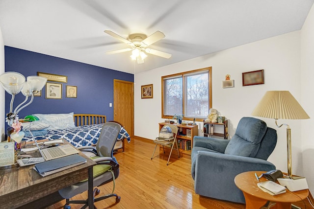 bedroom with ceiling fan and light hardwood / wood-style flooring