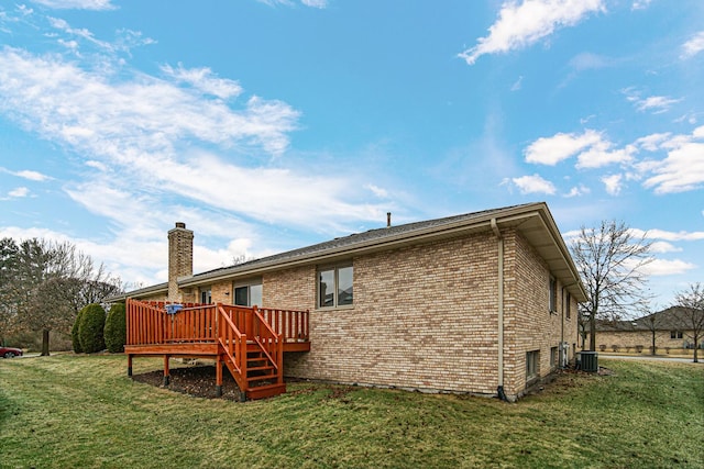 rear view of house featuring a wooden deck, a lawn, and cooling unit