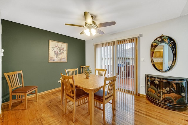 dining space with ceiling fan and light wood-type flooring