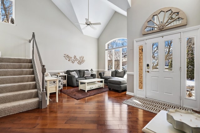 entrance foyer featuring dark hardwood / wood-style flooring, high vaulted ceiling, and ceiling fan