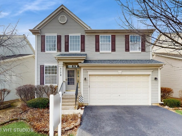 view of front of property with aphalt driveway and an attached garage