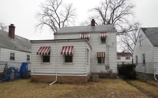 rear view of property with a yard