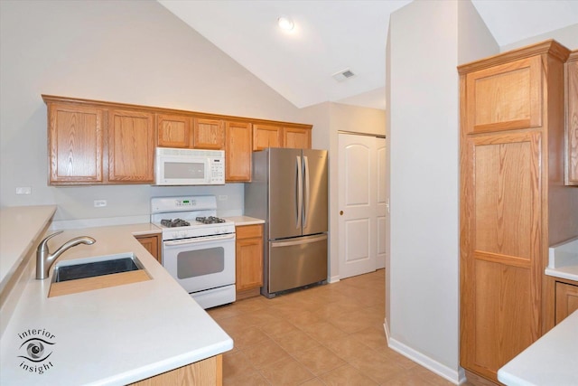 kitchen with white appliances, high vaulted ceiling, sink, and light tile patterned flooring