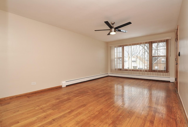 unfurnished room with ceiling fan, a baseboard heating unit, and light hardwood / wood-style floors