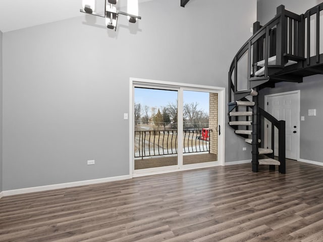 interior space featuring hardwood / wood-style flooring and a high ceiling