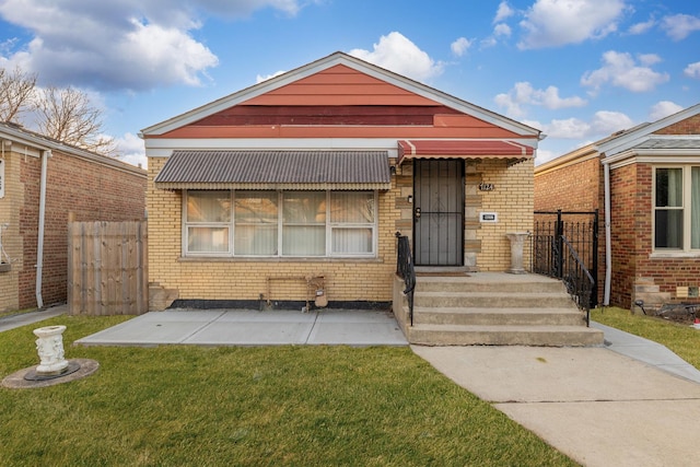 bungalow-style house featuring a patio area and a front yard