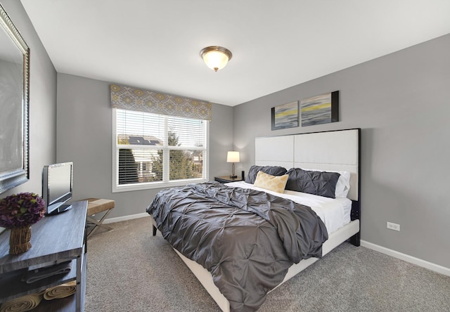 carpeted bedroom featuring baseboards