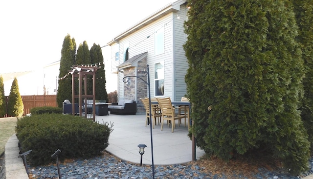 view of patio featuring outdoor lounge area and fence