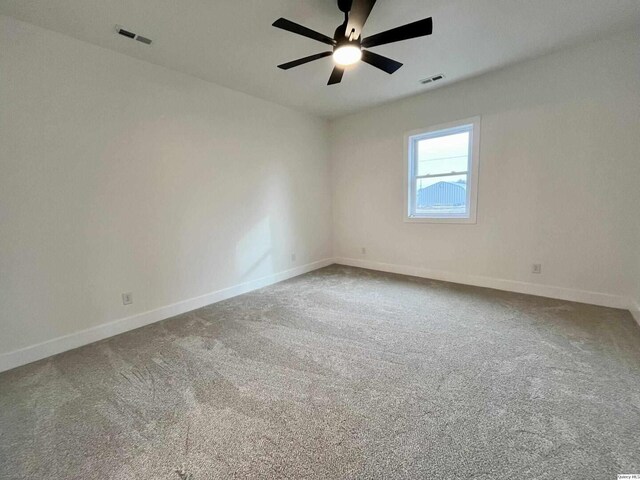 211 W Prairie St, Camp Point, IL 62320 - spare room with visible vents, baseboards, carpet flooring, and a ceiling fan