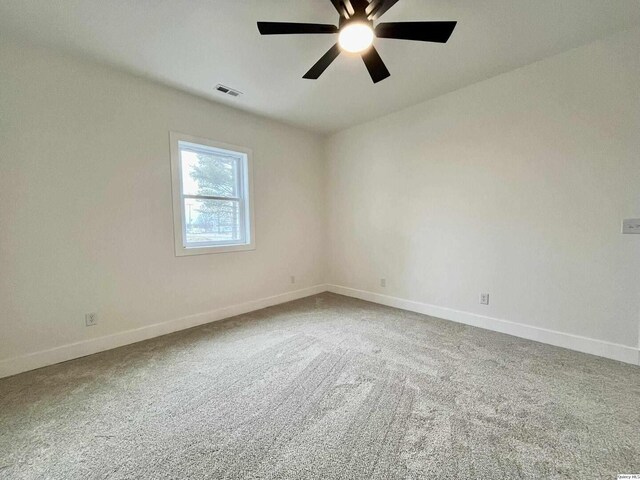 211 W Prairie St, Camp Point, IL 62320 - carpeted empty room with visible vents, baseboards, and a ceiling fan