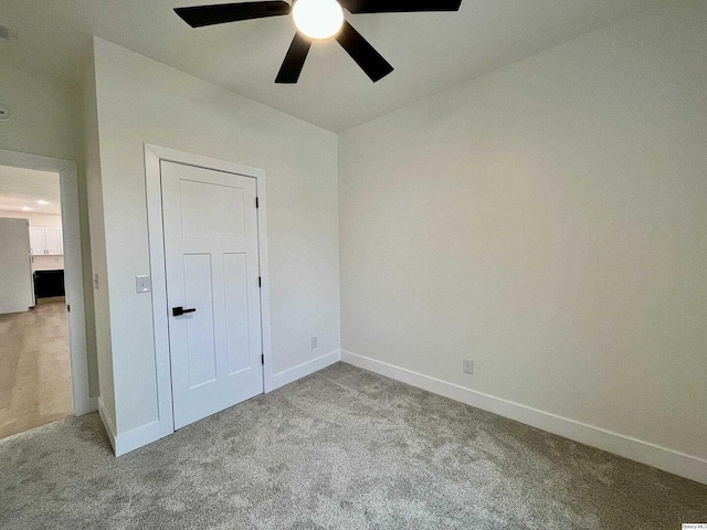 211 W Prairie St, Camp Point, IL 62320 - unfurnished bedroom featuring baseboards, a ceiling fan, lofted ceiling, and carpet flooring