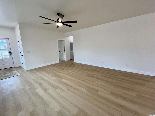 211 W Prairie St, Camp Point, IL 62320 - empty room with baseboards, a ceiling fan, and light wood finished floors