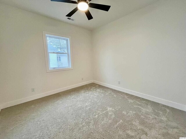 211 W Prairie St, Camp Point, IL 62320 - empty room with visible vents, baseboards, carpet, and ceiling fan