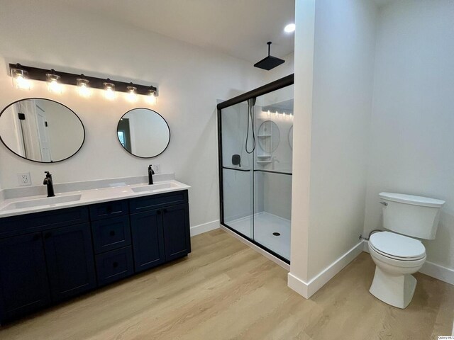 211 W Prairie St, Camp Point, IL 62320 - bathroom featuring a sink, baseboards, wood finished floors, and a stall shower