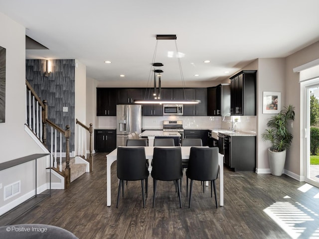 dining space featuring baseboards, stairs, visible vents, and dark wood-style flooring