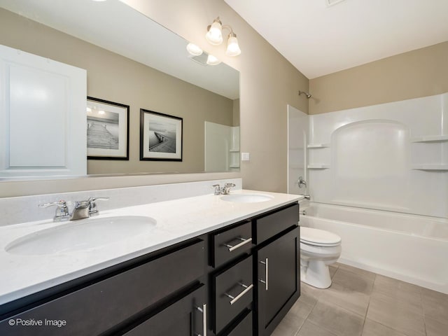 bathroom featuring double vanity, toilet, tub / shower combination, and a sink