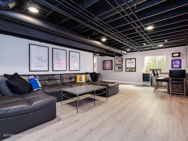 living area with light wood finished floors, wine cooler, and baseboards