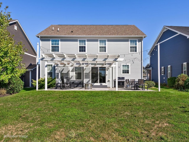 rear view of house featuring a patio, a lawn, and a pergola