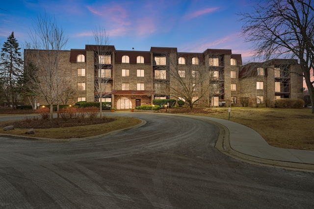 view of outdoor building at dusk