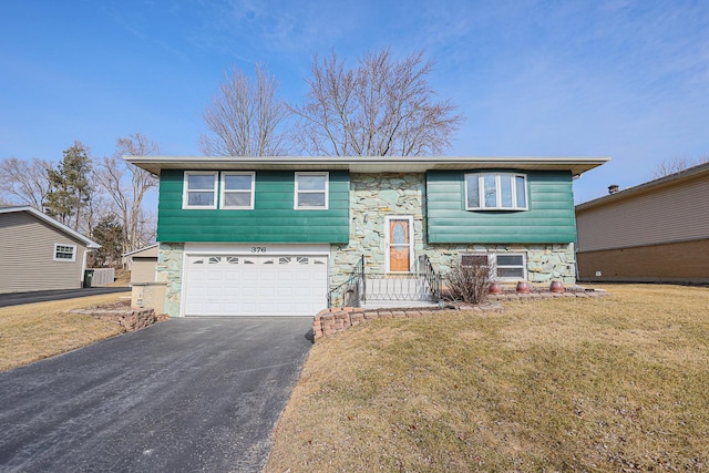 bi-level home with a garage and a front yard