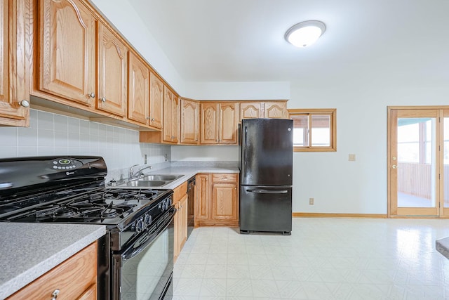 kitchen with sink, decorative backsplash, and black appliances