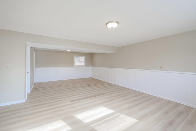 empty room with light hardwood / wood-style flooring