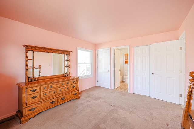 carpeted bedroom with connected bathroom