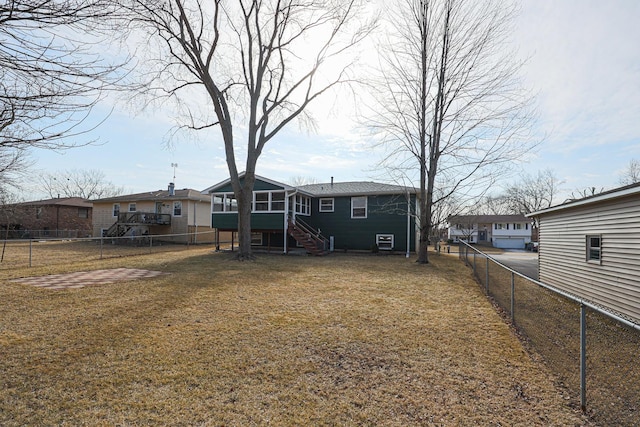 rear view of house featuring a lawn