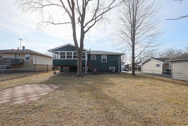 back of property featuring a patio, a sunroom, and a lawn