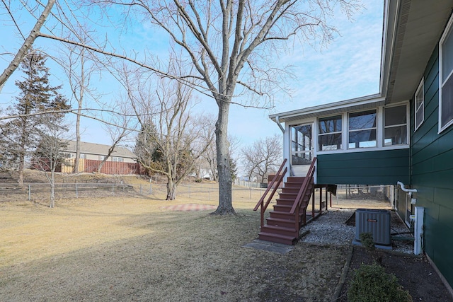 view of yard with cooling unit and a sunroom