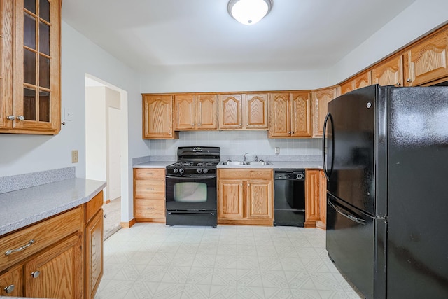 kitchen with sink, decorative backsplash, and black appliances