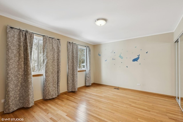 unfurnished room with crown molding and hardwood / wood-style flooring