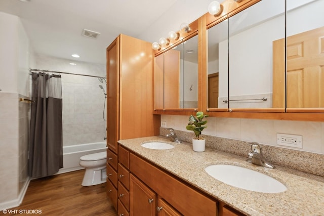 full bathroom with vanity, hardwood / wood-style floors, shower / tub combo with curtain, and toilet