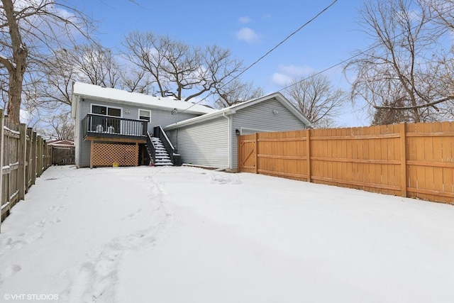 snow covered property featuring a deck