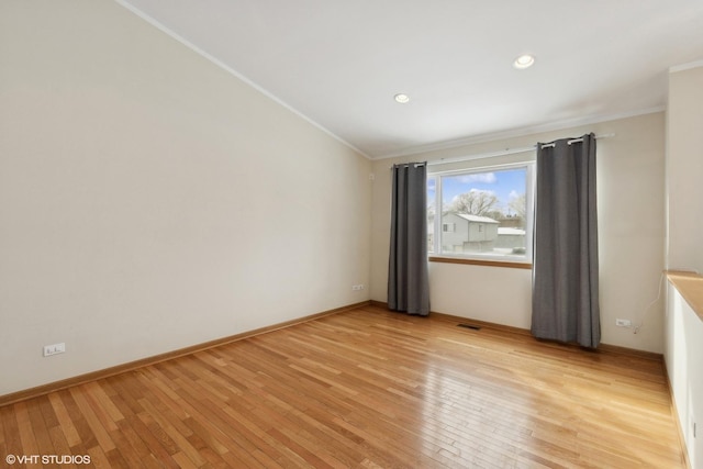 unfurnished room with crown molding and light wood-type flooring