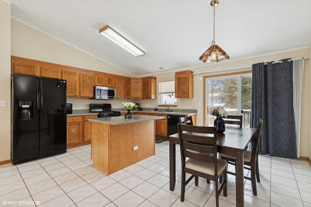 kitchen featuring decorative light fixtures, a center island, light tile patterned floors, a wealth of natural light, and black appliances